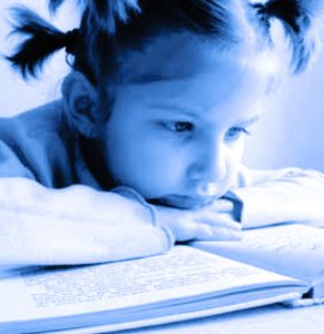 closeup of little girl reading a book