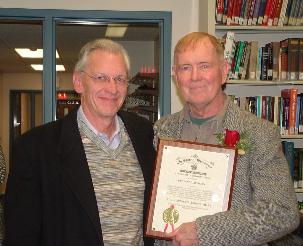 UW–Madison Chancellor John Wiley (left) stands beside Larry Jacobsen in December 2005, when Larry was awarded a Certificate of Commendation from the State of Wisconsin Office of the Governor for developing Primate Info Net as an internationally recognized resource for primate education and conservation. As part of the honor, the WNPRC library was renamed the Lawrence Jacobsen Library. (Photo by Edi Chan)