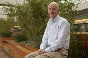 Stem cell pioneer James Thomson sitting in the atrium at the Wisconsin Institutes for Discovery.